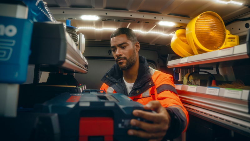 Un addetto al soccorso stradale recupera una cassetta degli attrezzi dall'interno del  Nuovo Caddy Cargo Volkswagen allestito come mezzo d'emergenza.
