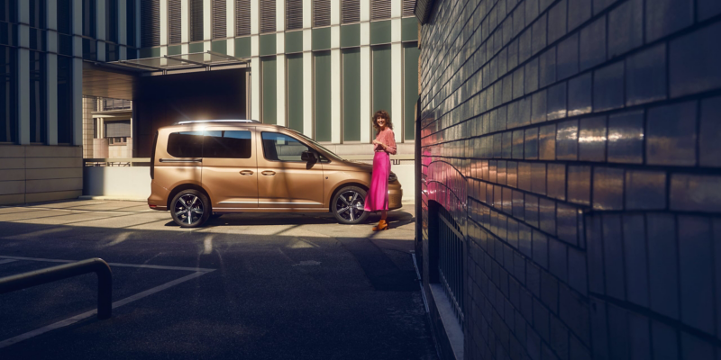 The new Caddy in front of a building complex.