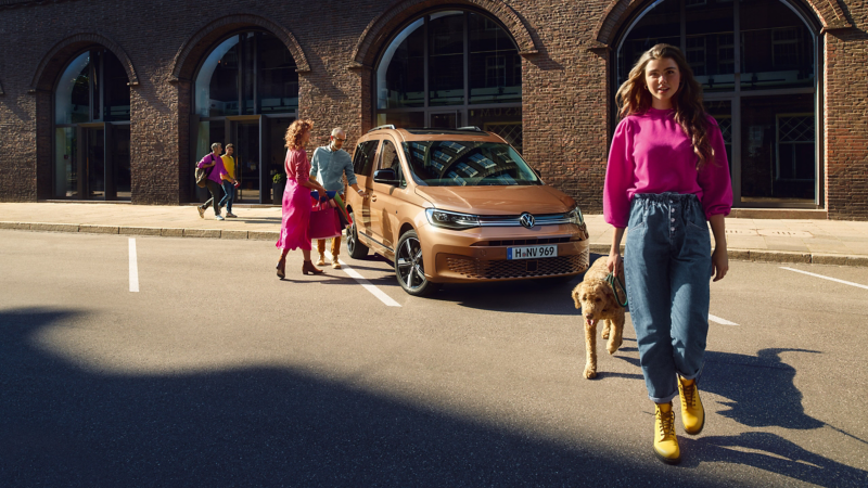 Ein VW Caddy parkt an einer Straße neben einem Backsteingebäude