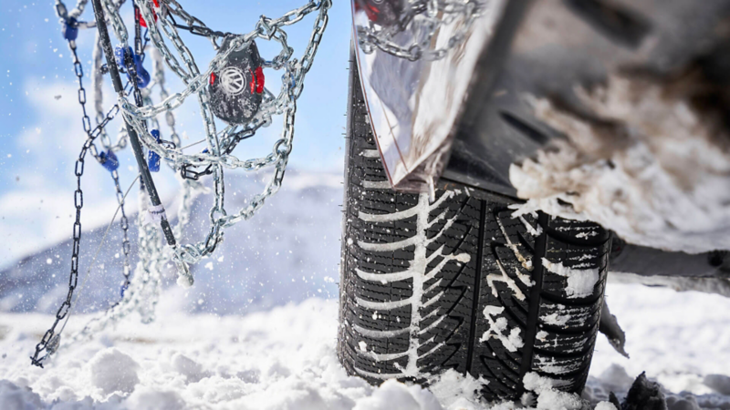 Gros plan d'un pneu et d'une chaine à neige Volkswagen.