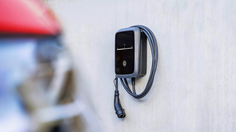 Un cargador eléctrico VW en la pared de una casa