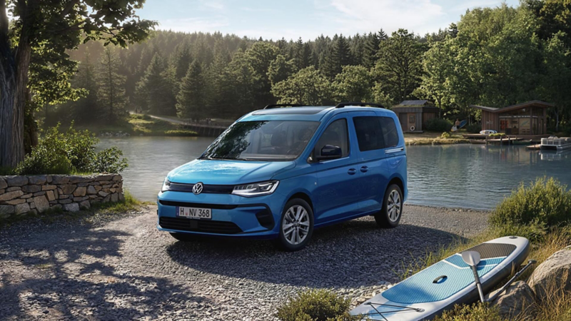 Un Volkswagen Caddy California delante de un lago
