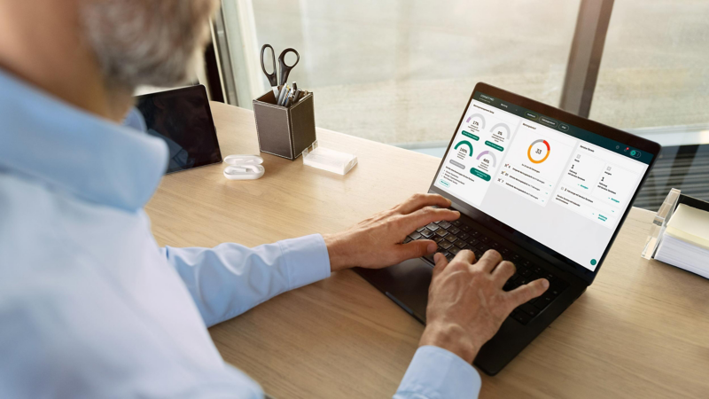 A man typing on a computer on a desk