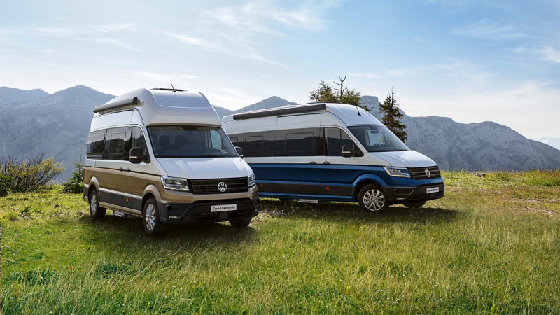 Two Grand California vehicles parked in a field