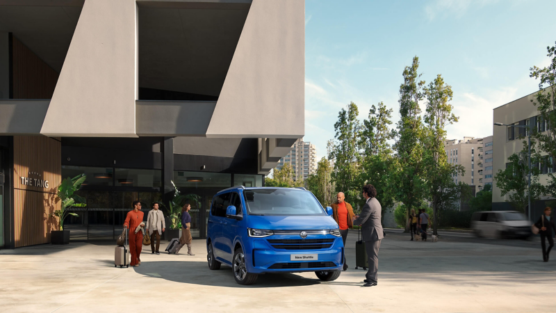 Blue Volkswagen Shuttle parked outside 