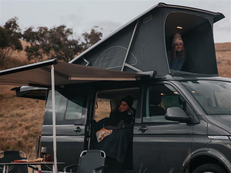 Family camping in Volkswagen California Campervan with pop-top.
