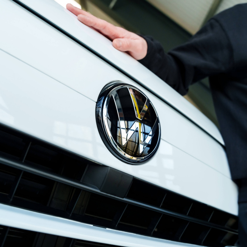Close up of the Volkswagen badge on a white Volkswagen van