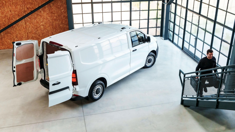 An electric VW e-Transporter van with the back doors opened