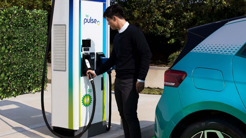 A man using a BP Pulse charging point. 