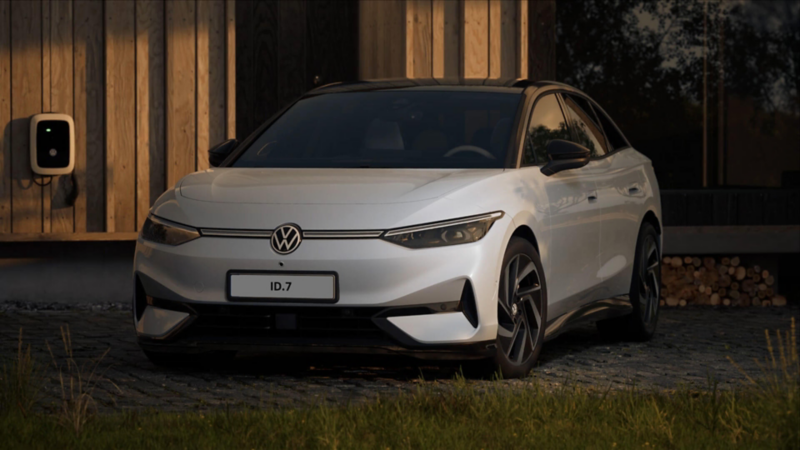 An ID.7 parked on a driveway plugged into a home charger