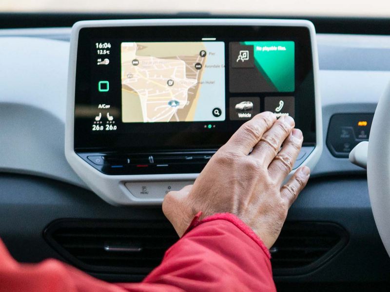 A passenger using the HMI system in a VW ID.3