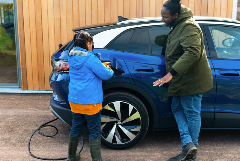 A parent and child charging an ID.4