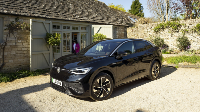 A black ID.5 parked outside a cottage