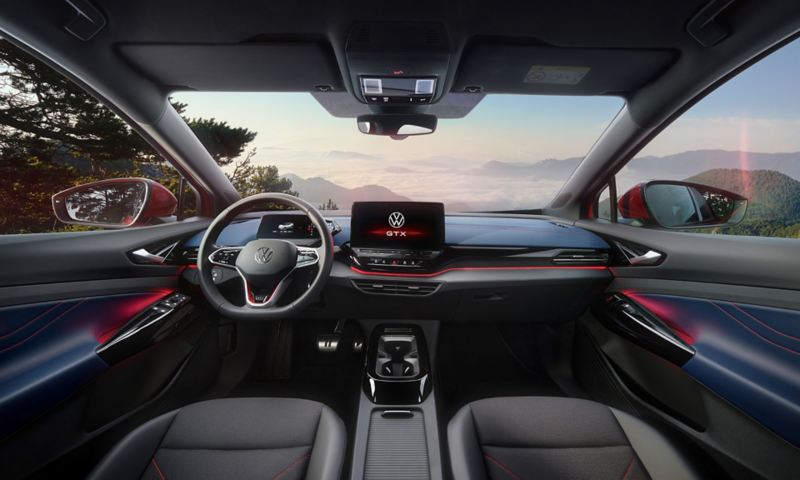 Interior of a red VW ID.5 GTX. View on steering-wheel, Display, seats,  dashboard, and rear-view mirror.