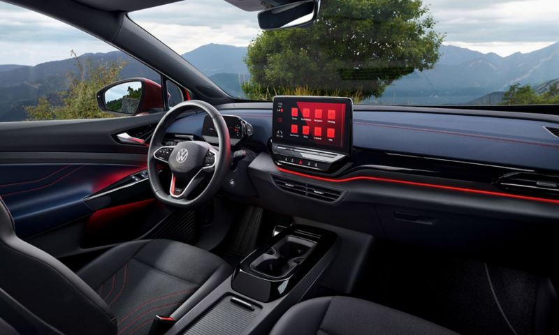 Interior of a red VW ID.5 GTX. View on steering-wheel, Display, seats, and dashboard.