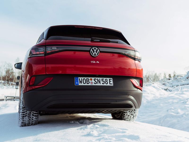 A rear shot of an electric VW car in the snow