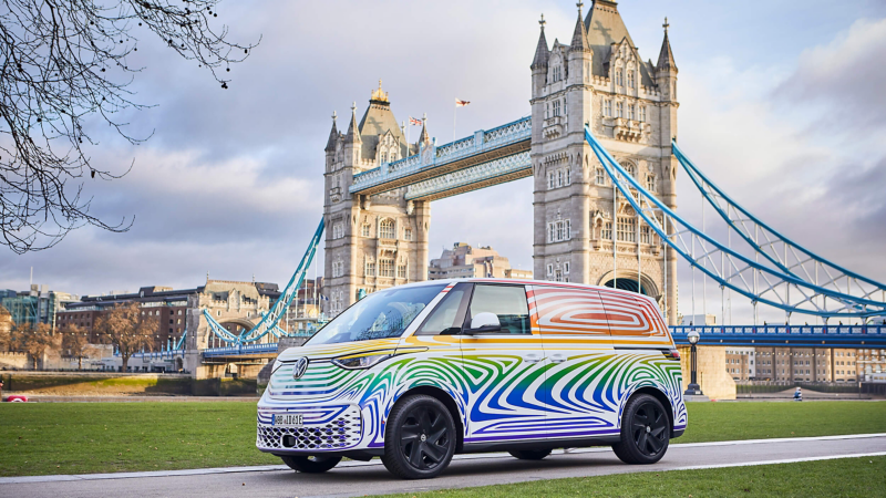 A rainbow coloured ID.Buzz parked in London against a London Bridge background. 