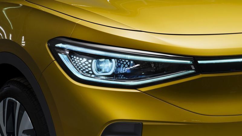 a close up of the headlights on a yellow ID.4