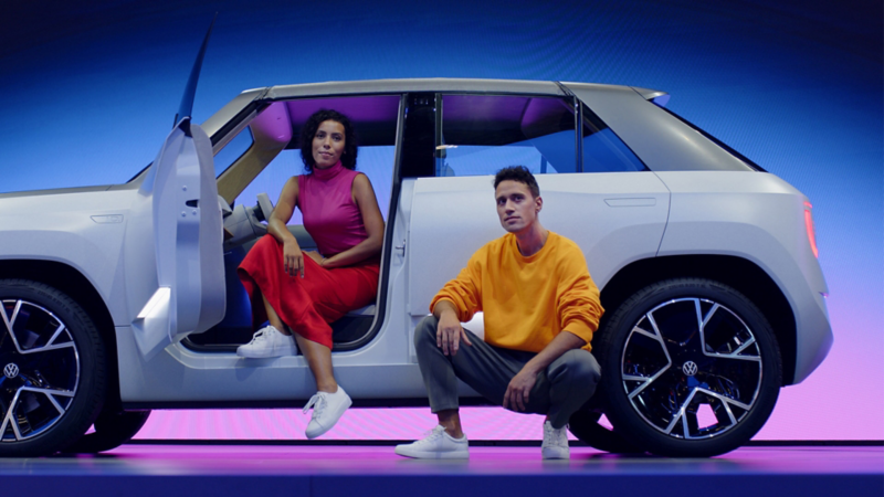 A woman and a man in and around the VW ID. LIFE