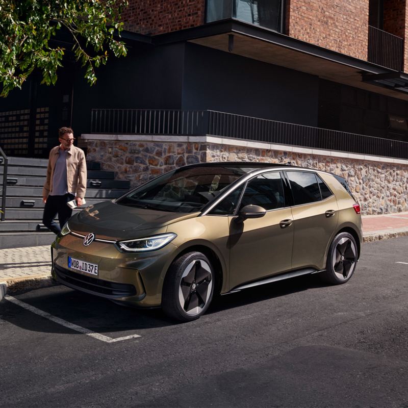 Person approaching VW car parked on residential street – certificate of conformity