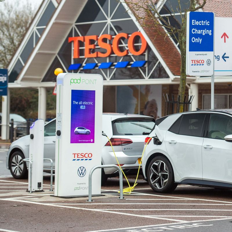 A Volkswagen e-Golf and ID.3 charging at a podPoint in front of a TESCO
