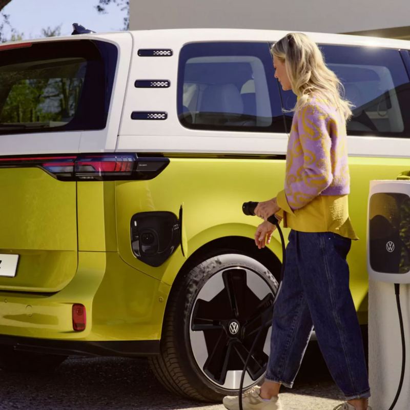 A man plugging an ID. Buzz into a charging station. 