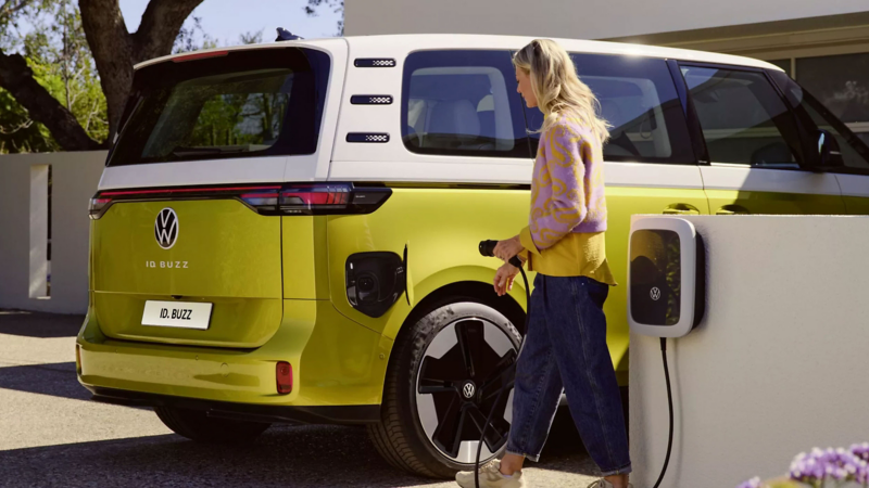 A man plugging an ID. Buzz into a charging station. 