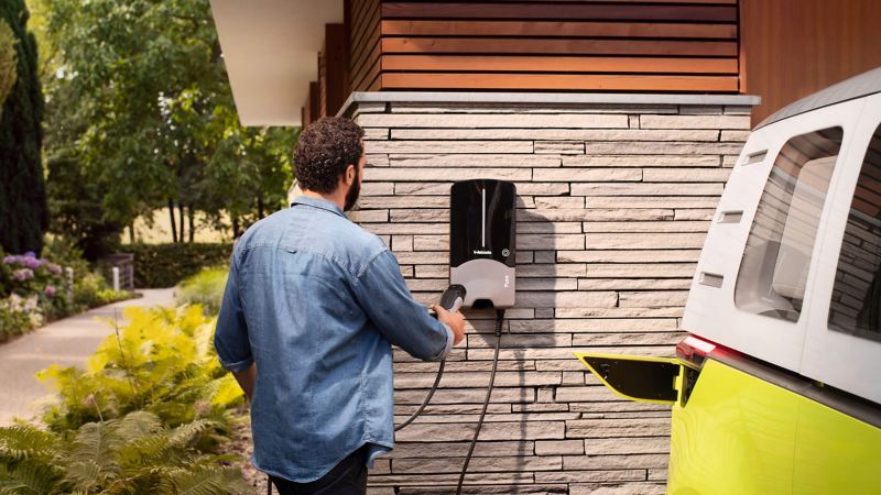 A man charging his ID.Buzz electric van