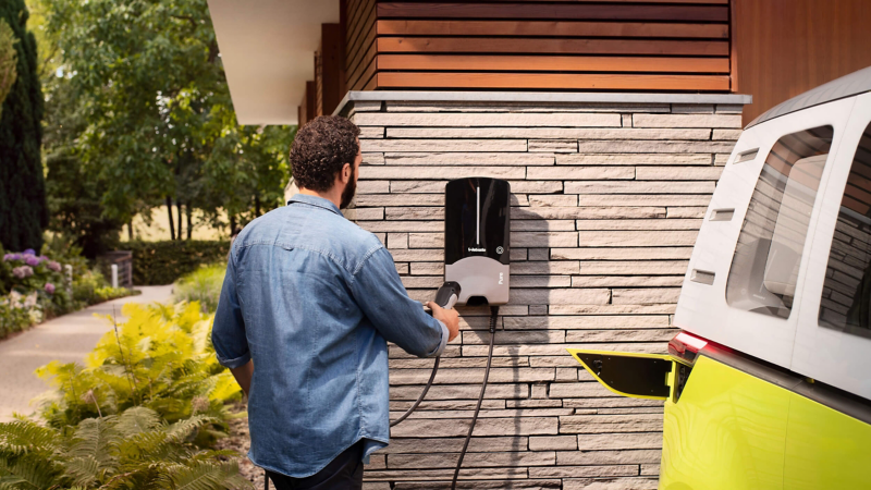 A man charging his ID.Buzz electric van