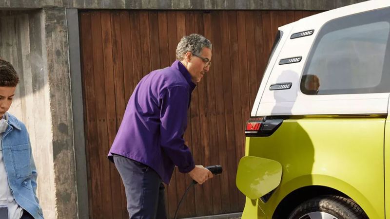 Photo showing a man plugging a charging cable into an ID. Buzz.