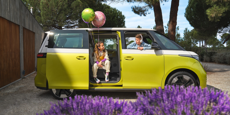 A family sitting inside a parked ID. Buzz.