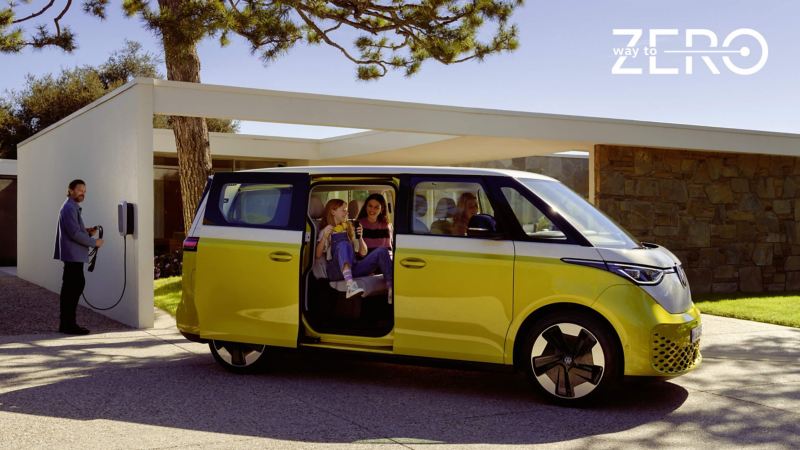 a person plugging in a yellow ID.Buzz into a home charging station