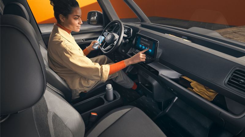 Interior shot of VW ID. Buzz Cargo with driver using infotainment