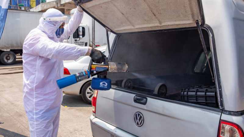 Empleado de Volkswagen desinfectando camioneta de carga como medida ante COVID-19