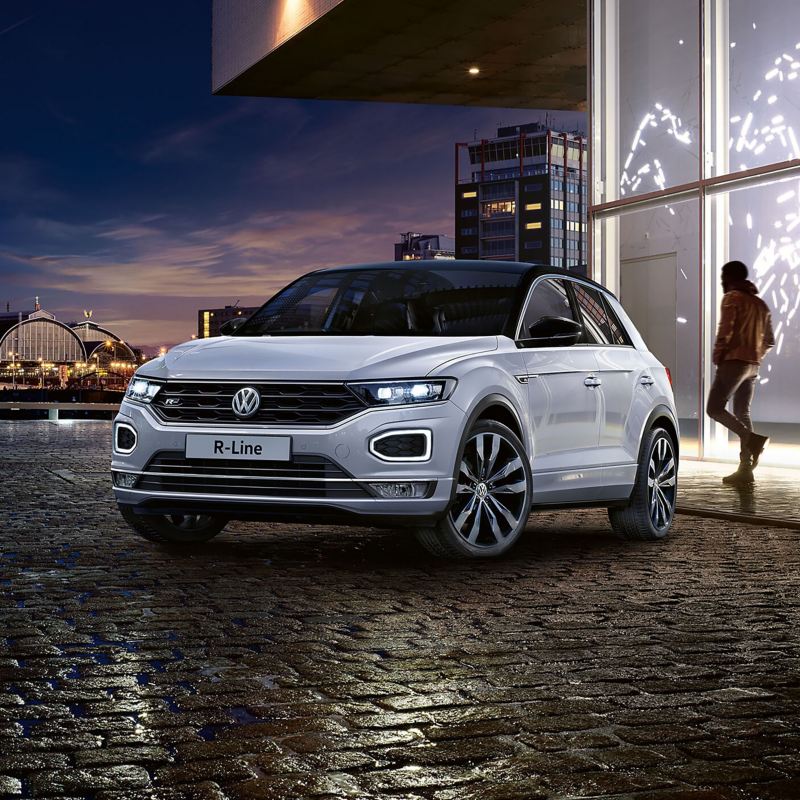 White Volkswagen T-Roc on a dark cobbled road