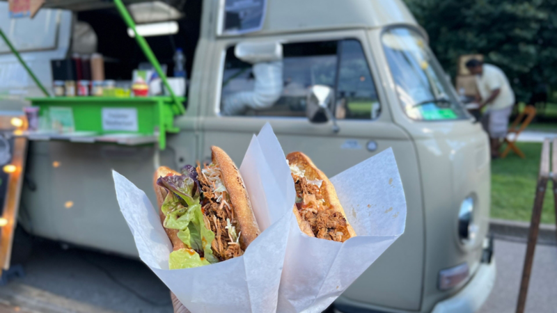 Sandwiches vor einem Foodtruck mit Volkswagen Oldtimer.