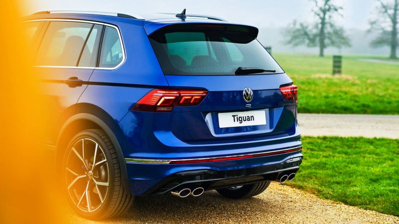 A side on view of a blue Tiguan R driving along a road