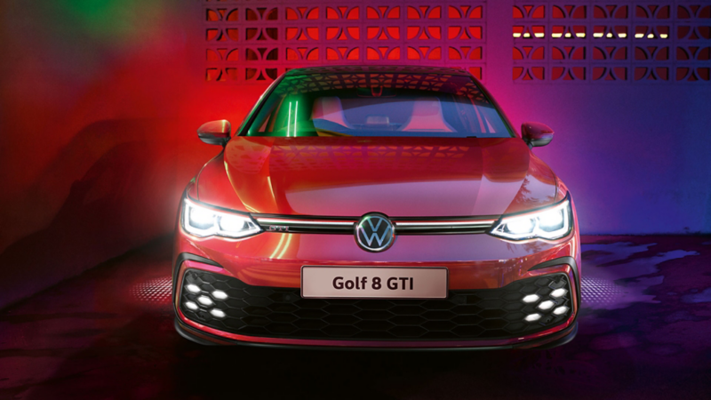 VW Golf GTI in red, front view, glowing IQ.Light headlights