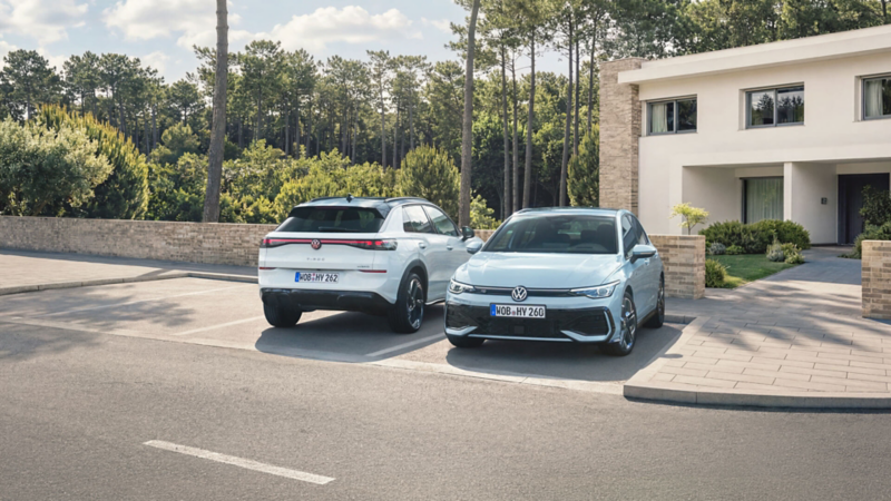 Une Golf de face et un T-Roc Hybrid de dos, garés devant un pavillon.