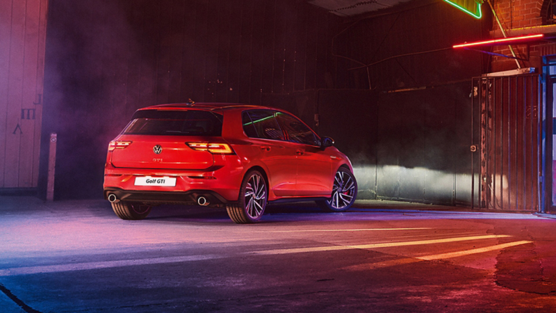 VW Golf GTI in red, rear view, parked in a warehouse