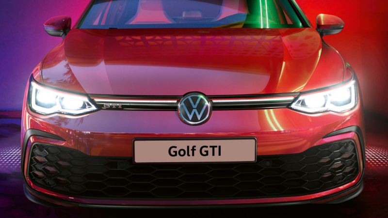 VW Golf GTI in red, front view, glowing IQ.Light headlights