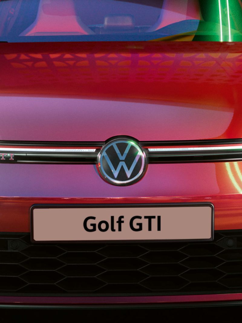 VW Golf GTI in red, front view, glowing IQ.Light headlights