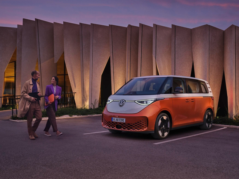 El VW Nuevo California aparcado en la orilla junto a dos personas.