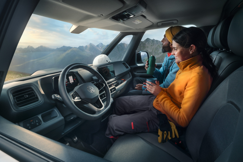 Couple sitting in van on a hiking trip