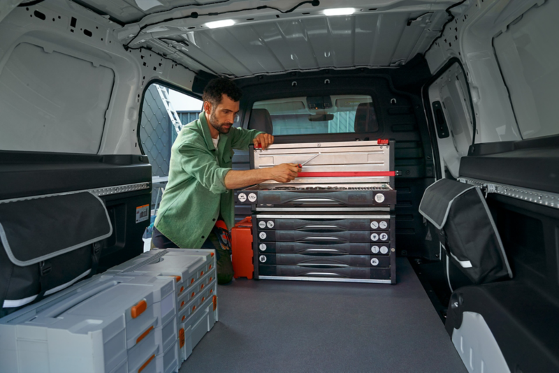 Volkswagen ID. Buzz Cargo space, man taking tools out of tool box