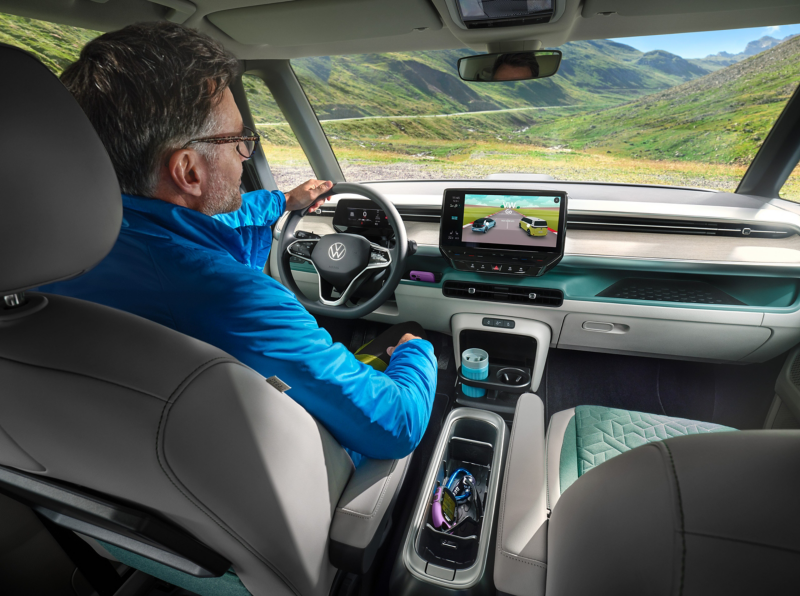 A man plays the car racing game “VW Go” in a VW.