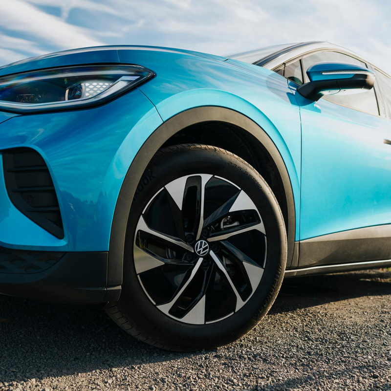 Woman standing with ID. 4 Pro parked behind her