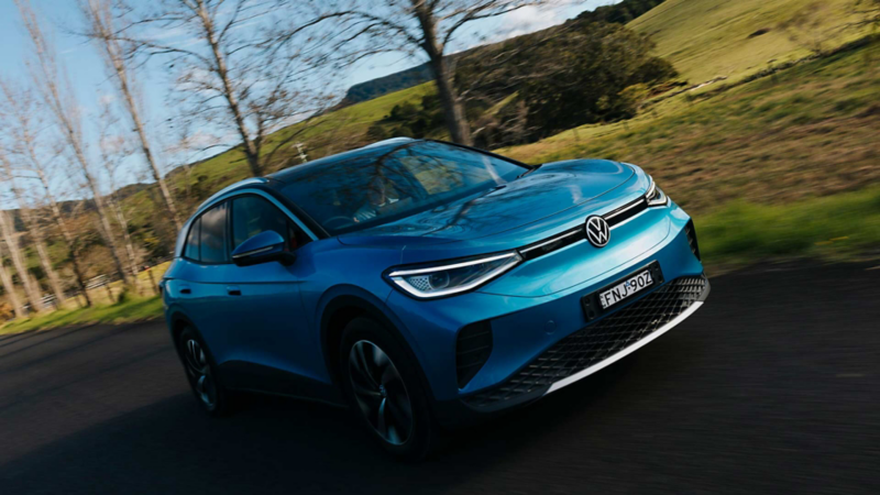 Blue car driving on mountainous road