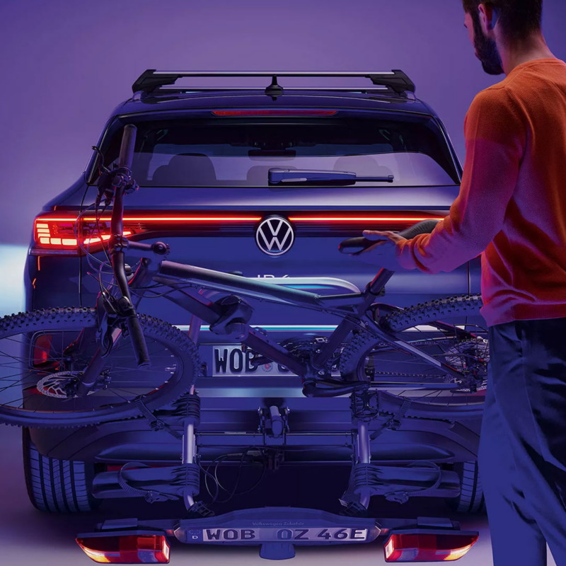 Man loading bike onto car bike carrier