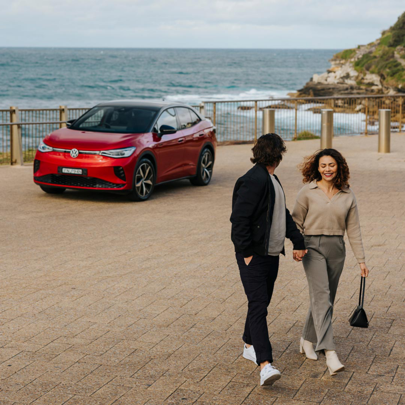 Couple walking with ID 5 GTX parked behind them